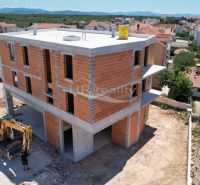 Construction of a recreational apartment in Vodice with brick walls and a view of the surrounding houses.