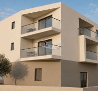 The exterior of the building of the Recreational Apartment in the city of Vodice with modern balconies and a tree.