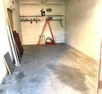 In the garage on Čmelíkova Street in Bratislava - Ružinov, there are stairs and a simple shelf.