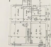 Floor plan of a family house with multiple rooms and dimensions, suitable for renovation.