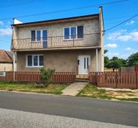 A family house in Záhorská Ves with a garden and a balcony on the upper floor.