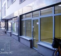 Glass-walled offices on Lichnerova Street in Senec with a parked bicycle.