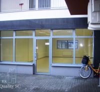 The glass facade of the office on Lichnerova Street in Senec with a bicycle parked outside.
