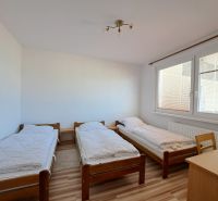 Three single beds, wooden decor, bright room, 3-room apartment.