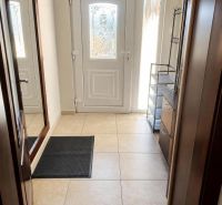 Entrance hall with tiles and white doors in a family house.