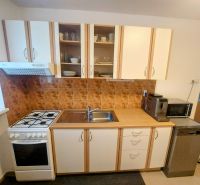 A kitchen with a kitchenette and appliances in a 2-room apartment.