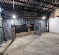 Warehouses and halls with metal doors and high ceilings.