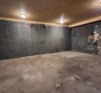 A space with a concrete floor and lighting, ideal for storage purposes.