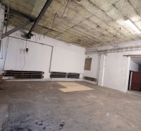 Empty interior in warehouses and halls with concrete floor and pipes on the wall.