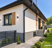 A family house in Lipany with a white facade, wooden elements, and a garden.