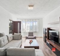 Kitchen and living room in a 2-room apartment with a wooden decor floor.