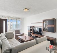 A kitchen in a 2-room apartment with a wooden floor decor and stainless steel appliances.