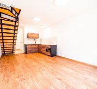 A kitchen with wooden decor, a staircase, and a wooden decor floor in a holiday apartment.