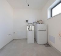 Utility room with a boiler and water connections in a family house.