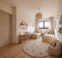 Children's room with two beds, window, light-colored walls, wooden decor flooring, family house.
