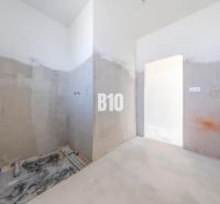 Unfinished space with concrete walls, with installation outlets in a family house.