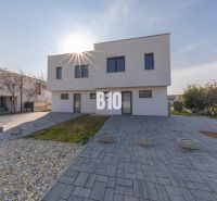 A family house in Senec on a street in Senec with a landscaped yard and paving.