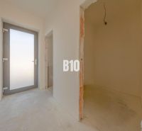Entrance hall with concrete floor and glass doors in a family house.
