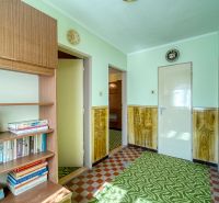 Library with books in a family house, entrance hall with carpet and wooden wall decor.