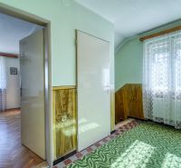 Interior of a family house with a wooden decor floor and a patterned carpet.