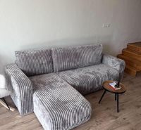 A stylish gray sofa combined with a wooden decor floor in the cottage.
