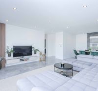Living room in a family house with a couch, television, and decorative elements.