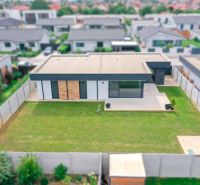 A family house on Milénium Street, Košúty, with a flat garden and minimalist design.