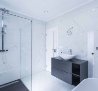 Bathroom in a family house with an elegant shower and sink.