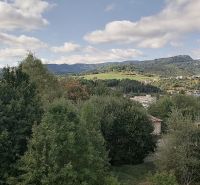 Greenery and hills in Banská Bystrica, on Astrová Street, surround the family houses.