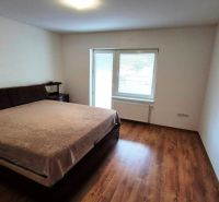 Bedroom in a 3-room apartment with a large bed and a floor with a wooden decor.