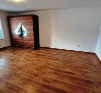 A room with a wooden floor decor and a wardrobe in a 3-room apartment.