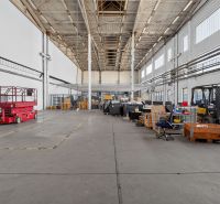 A spacious hall with a high ceiling and various equipment in warehouses and halls.