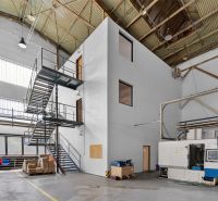 Interiors of warehouses and halls with industrial stairs and machinery, without wooden decor.