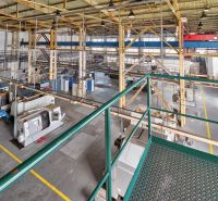 A production hall with a number of machines, a staircase, and a steel structure in warehouses and halls.