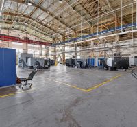 Space warehouses and halls with production machines and a metal roof structure.