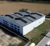 Near the warehouses and halls in Trenčín on K výstavisku Street, a modern industrial building can be seen.
