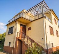 A family house in Dvory nad Žitavou with a balcony and external stairs.