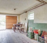 Garage in a family house with a workbench and stored items.