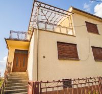 A family house in Dvory nad Žitavou with wooden shutters and a spacious terrace.
