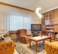 Living room in a family house with retro furniture and comfortable armchairs.