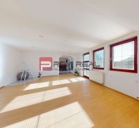 Living room in a 4-room apartment with a wooden decor floor and large windows.