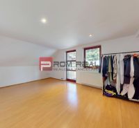 A space in a family house with a wooden decor floor and a wardrobe.