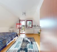 A room in a 5 or more bedroom apartment with a wood-decor floor and a bed.