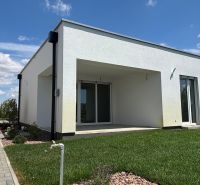A family house in Boldog with a well-maintained garden, paved walkway, and spacious terrace.
