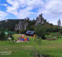 Recreational plots in Turany with a playground and rock formations on a green meadow.