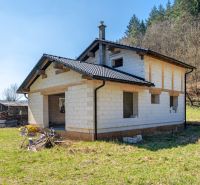 A family house in Lazy pod Makytou, an unfinished building surrounded by nature and greenery.