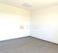 Empty room with neutral walls and large tiles on the floor, suitable for commercial properties.