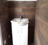 A sink in a bathroom with wooden decor walls, Plots - commercial.