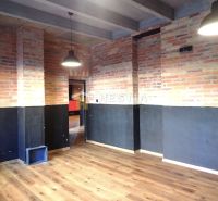 Brick walls and a wooden decor floor in commercial spaces.
