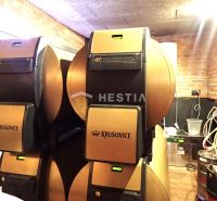 Beer kegs in commercial spaces with brick cladding and cables on a wooden-decor floor.